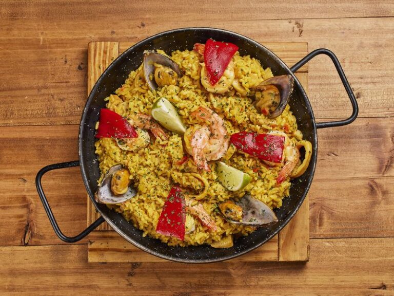 Seafood paella with shrimp, mussels and roasted red peppers in a traditional pan at El Pimiento Restaurant in Miami Lakes